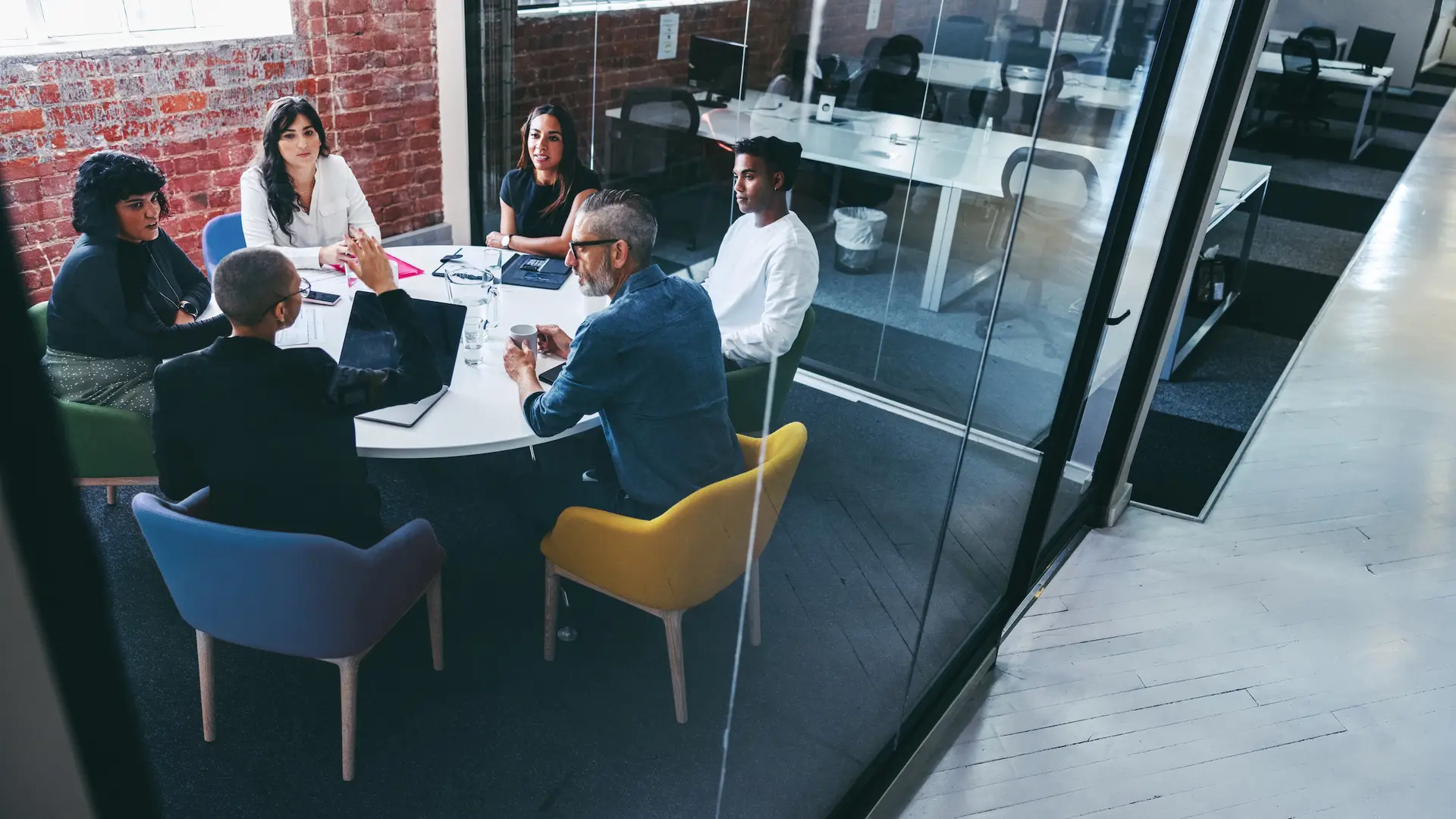 Board strategy meeting in progress - Reputation Matters Diverse group of professionals in a strategy meeting around a round table