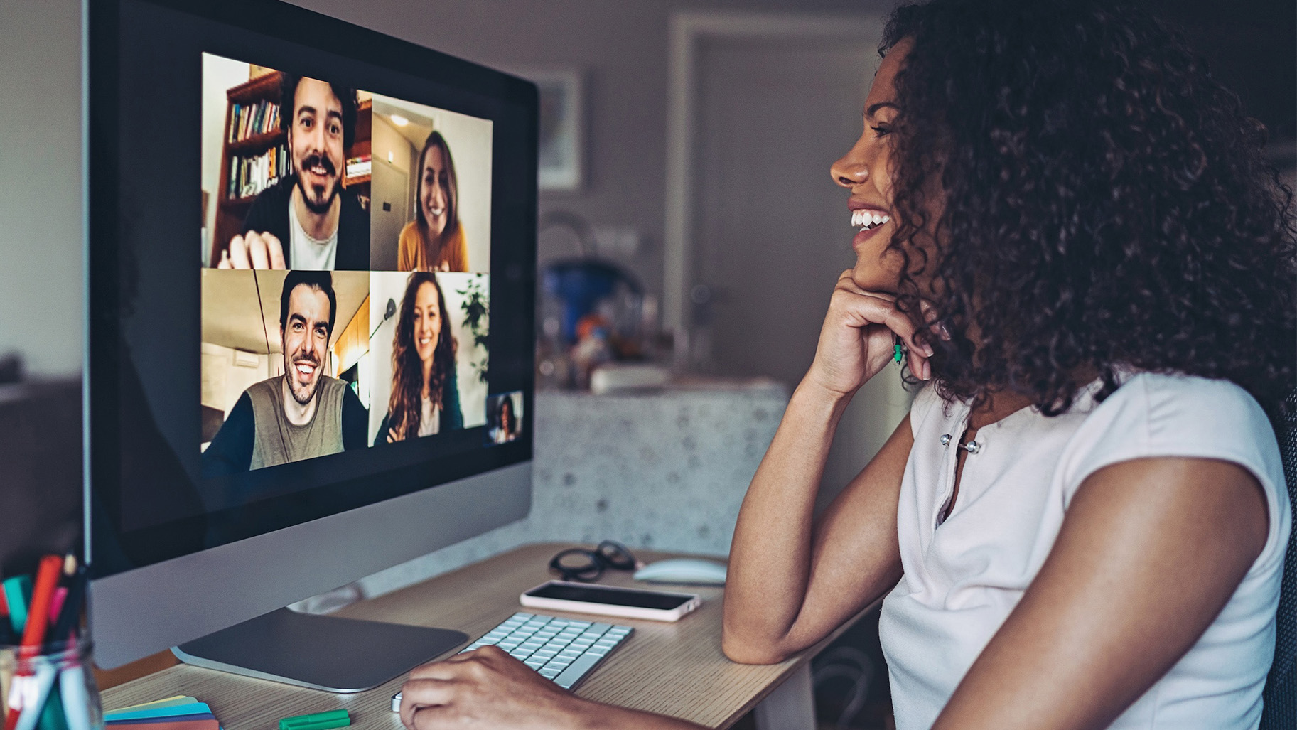 Board expert advises board members during hybrid in-person and virtual meetings with one board member joining laptop