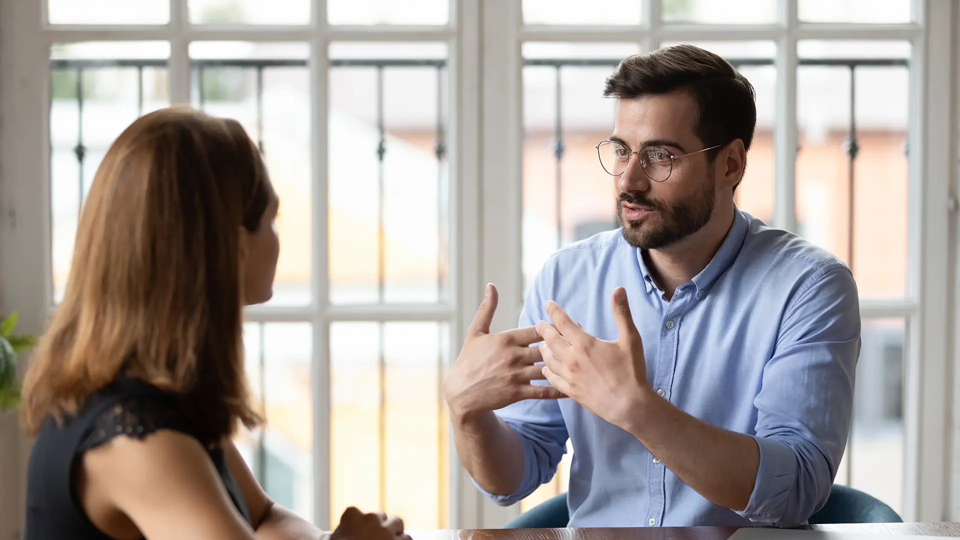 Smiling bearded man in glasses with confident body language
