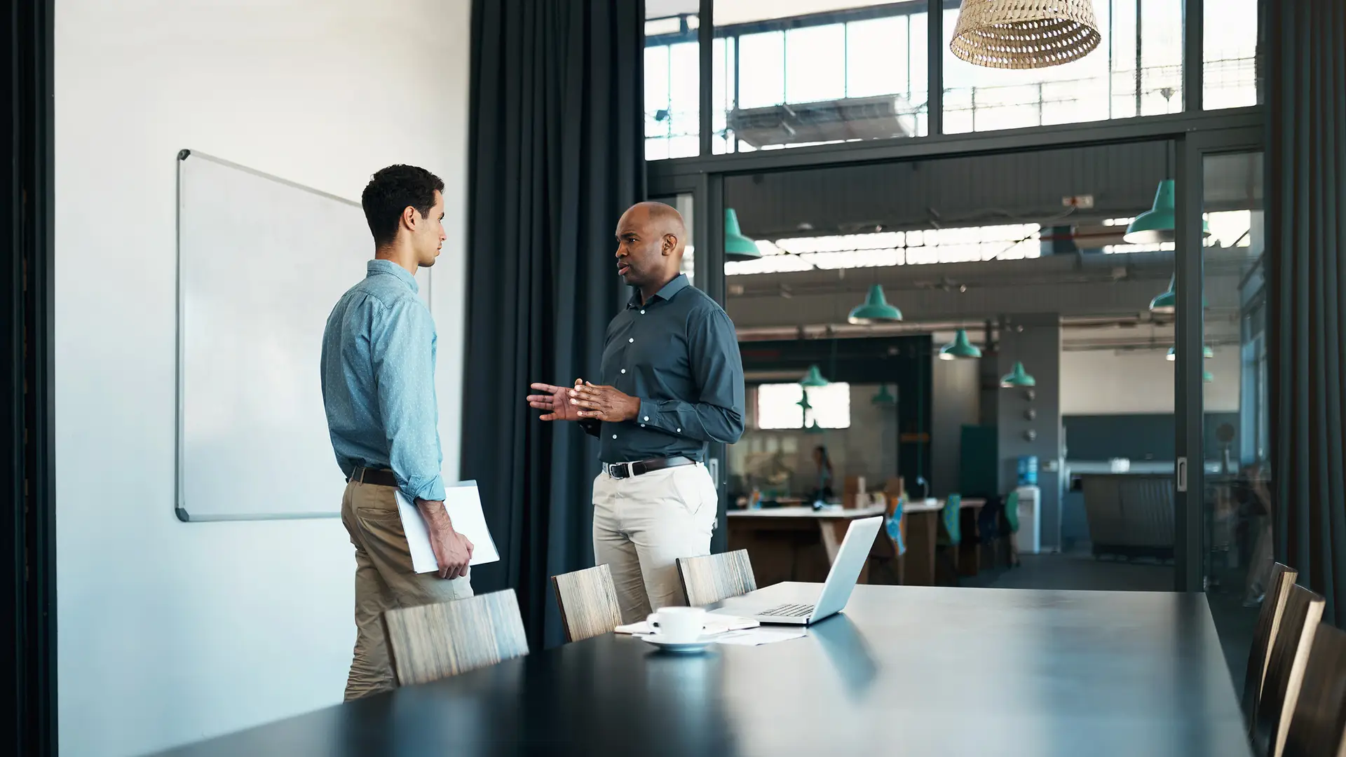 Two men in conference room having a serious conversation