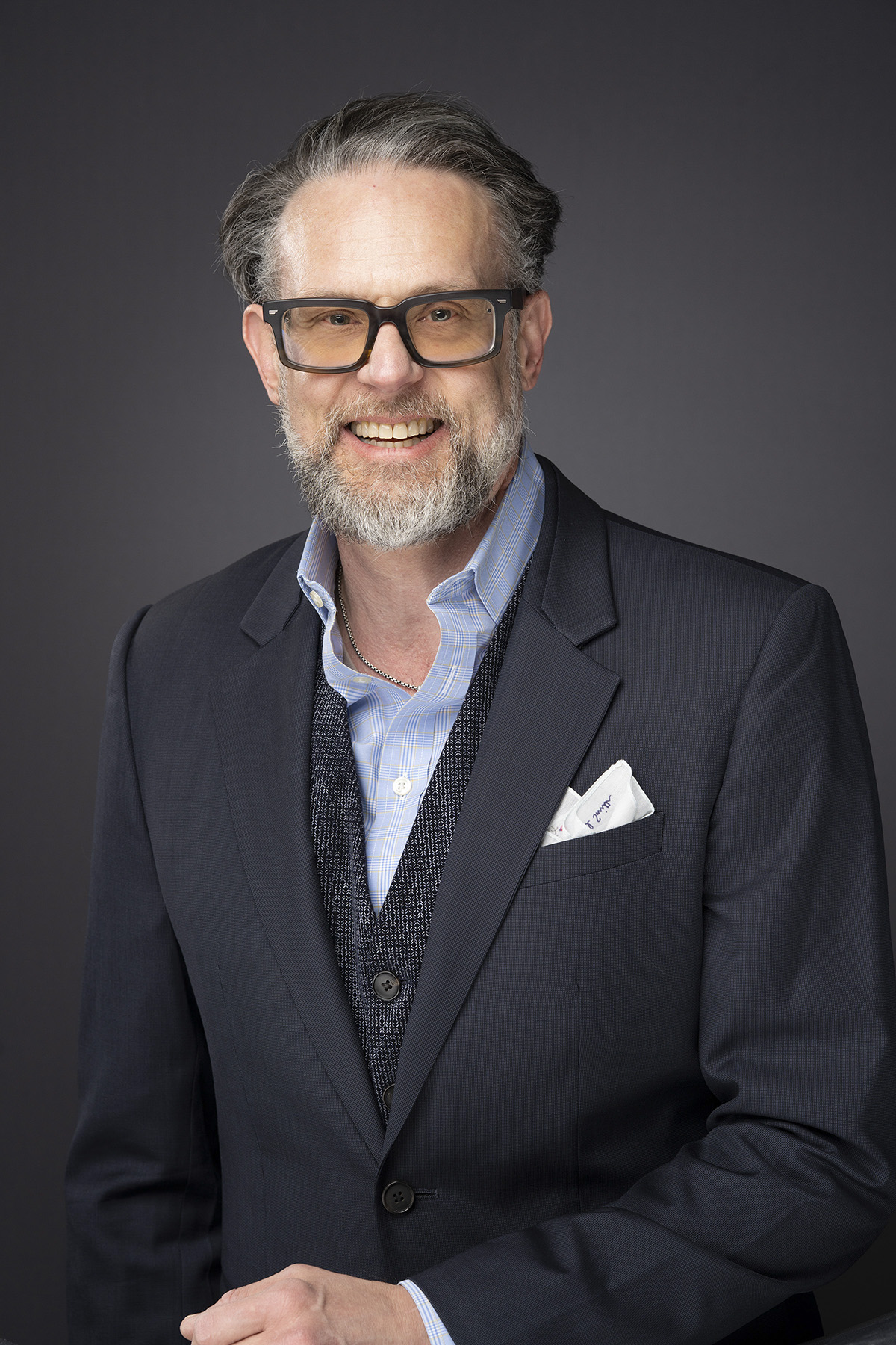 Board Consulting 2 Portrait of Paul Thomas, founder of Reputation Matters, in a navy suit against a dark studio background.